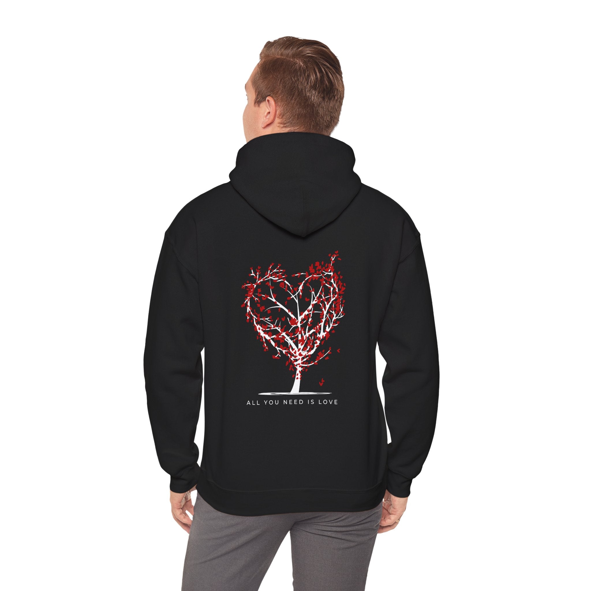 Person wearing a black hoodie with a red heart design and text on the back, on a white background