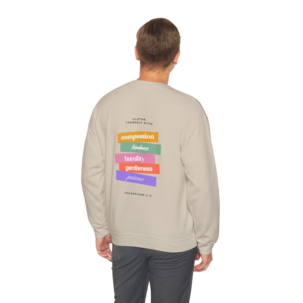 Person wearing a beige sweatshirt with colorful text on the back against a white background