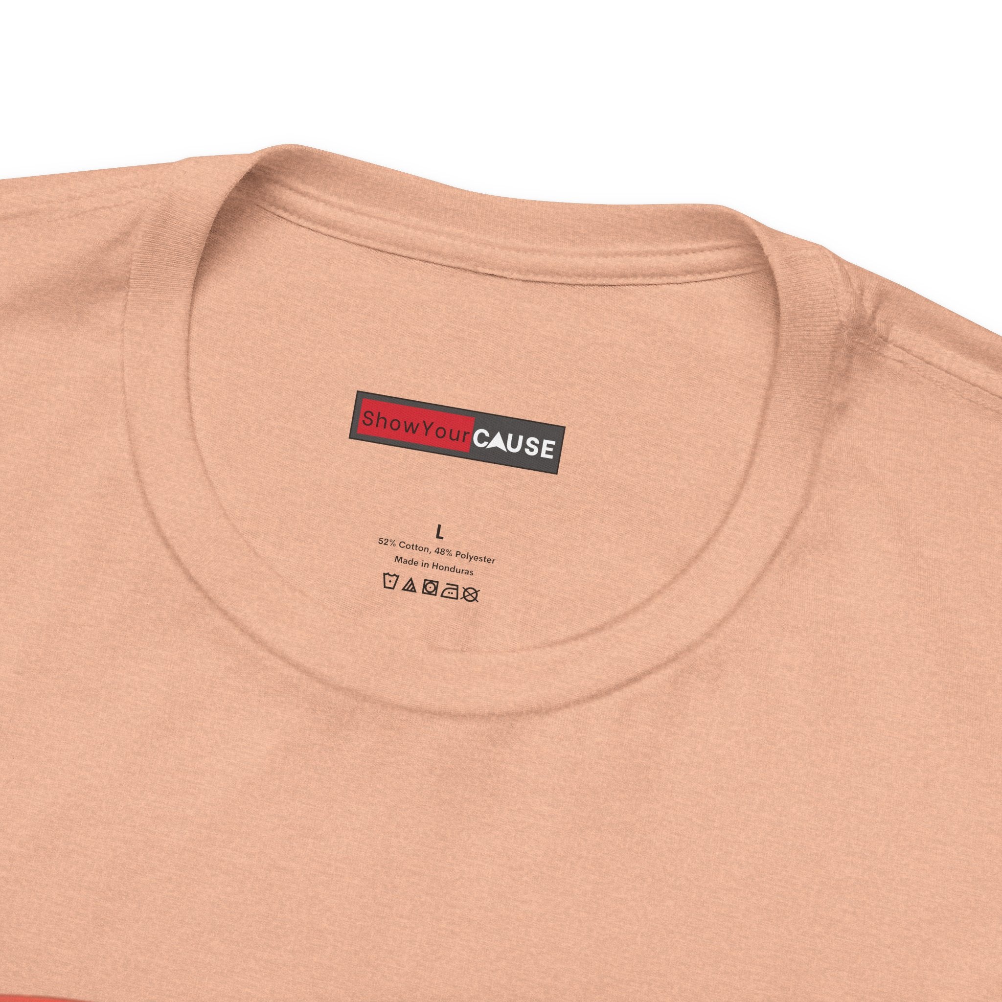 Close-up of a beige t-shirt with a 'Show Your Cause' label on a white background