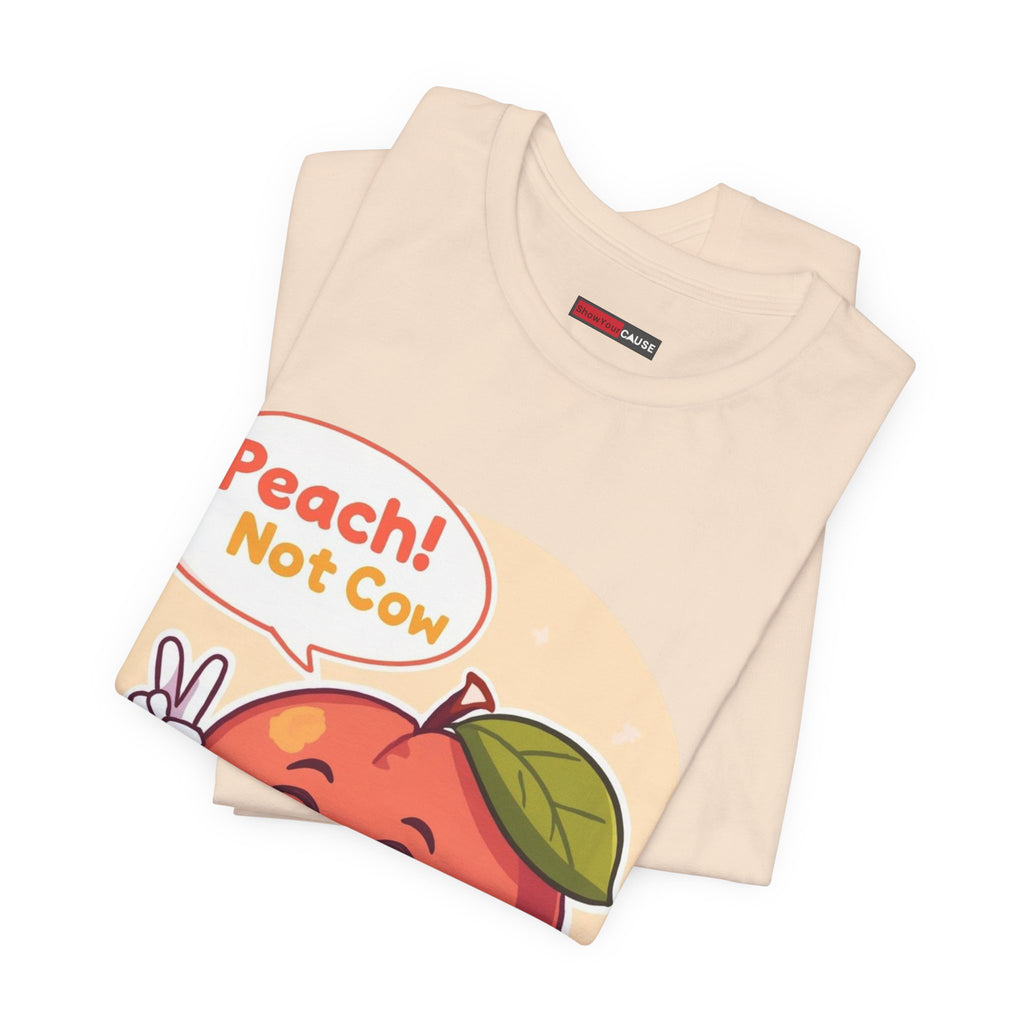 Folded beige t-shirt with a colorful graphic and text on a white background