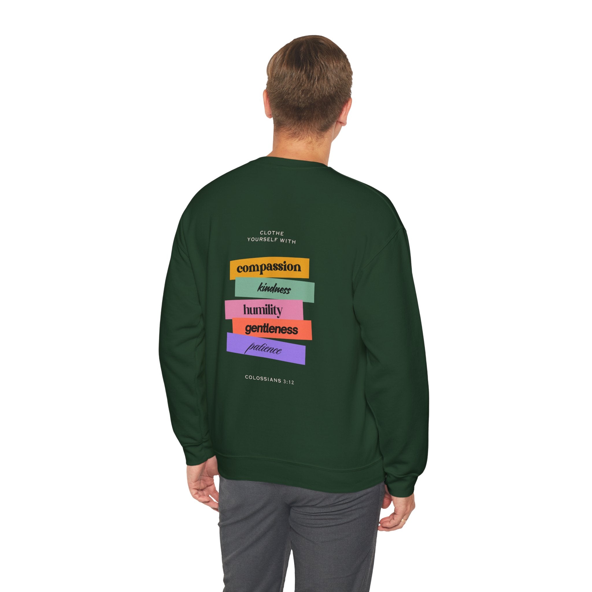 Person wearing a green sweatshirt with colorful text design on the back