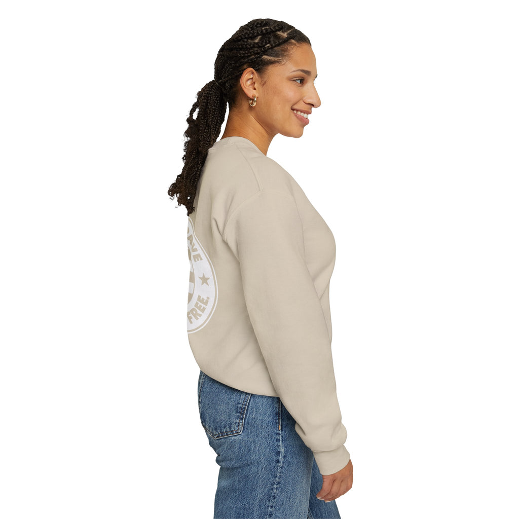 Woman wearing a beige sweatshirt with a logo on the back, standing against a white background