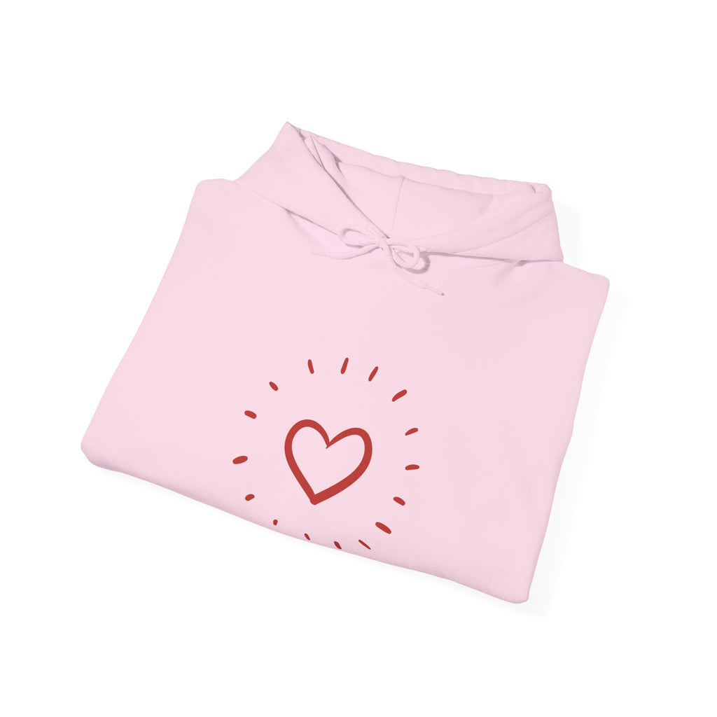 Pink folded garment with a red heart design on a white background