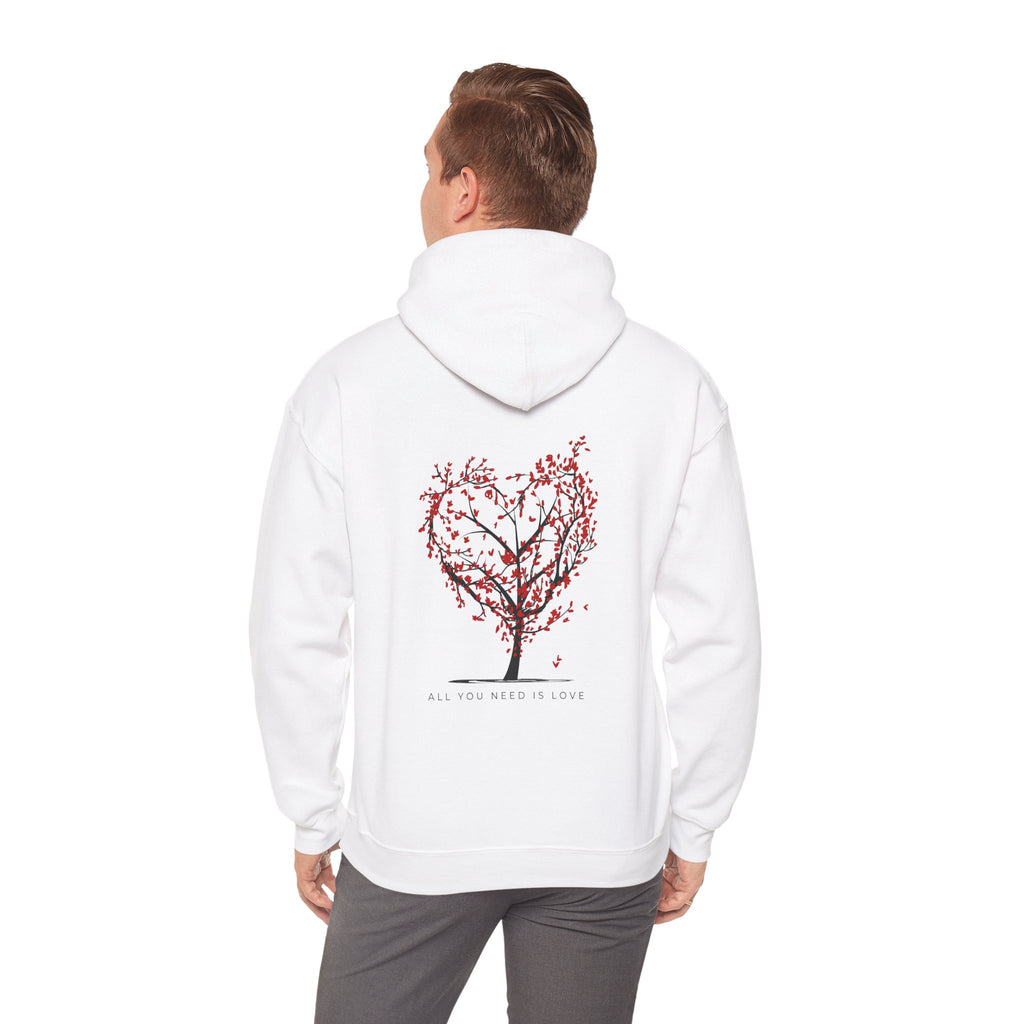 Person wearing a white hoodie with a red tree design on the back, standing against a white background.