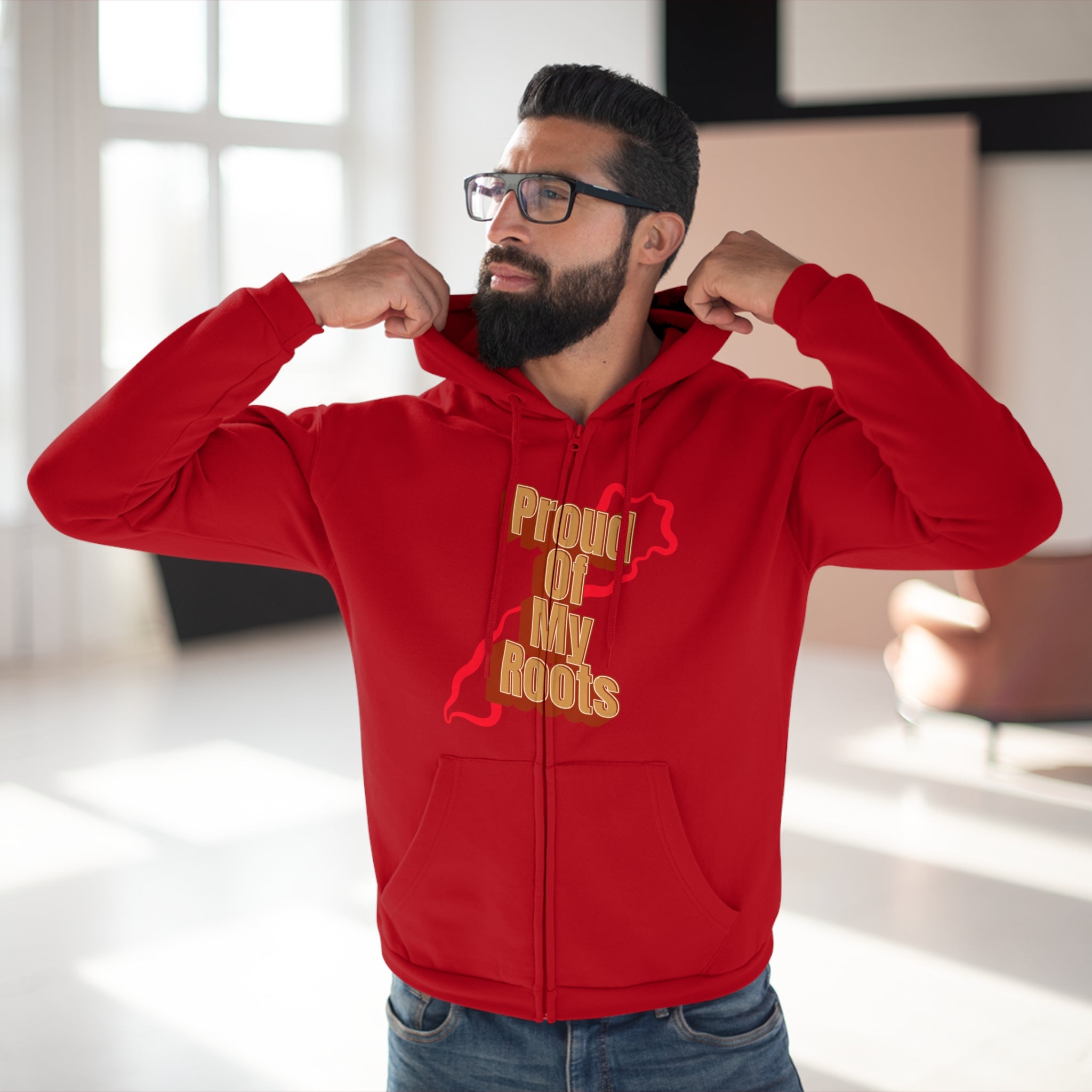 Man wearing a red hoodie with gold text indoors