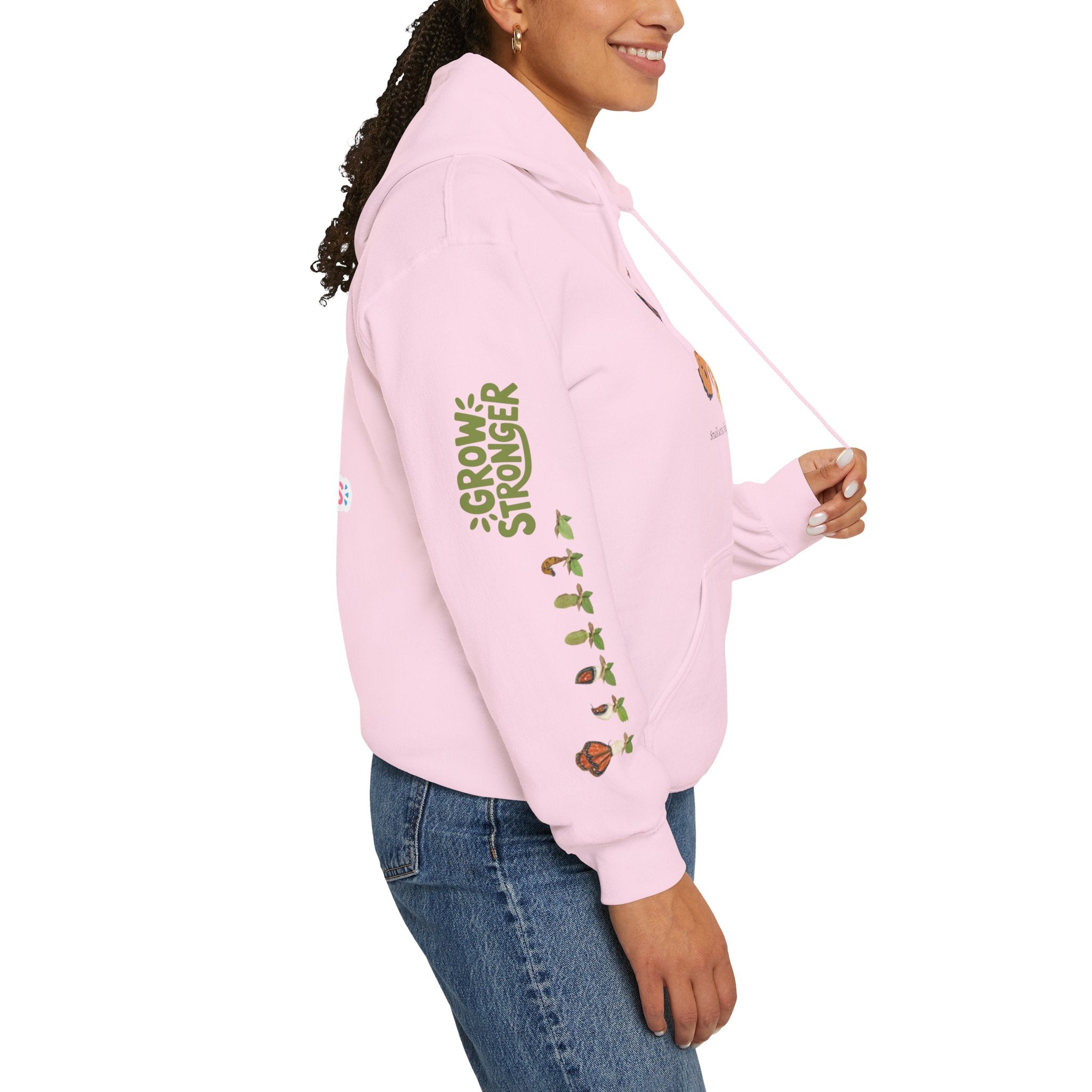 Person wearing a pink hoodie with text and graphics on a white background