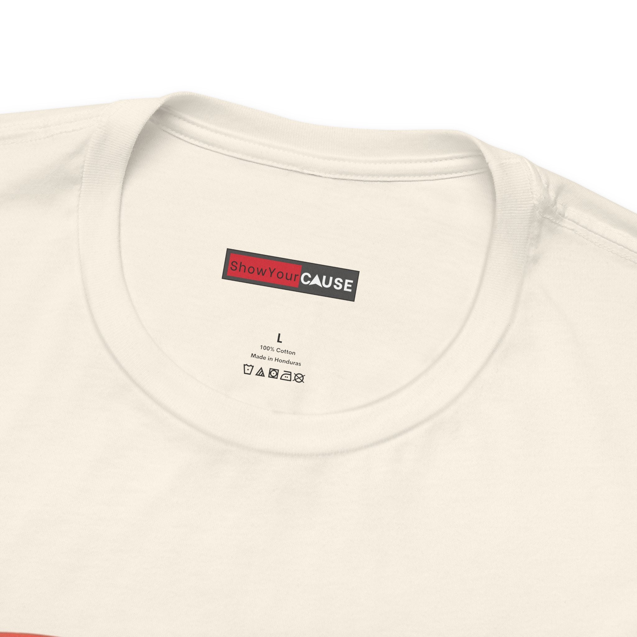 Close-up of a cream-colored t-shirt with a label on the collar.