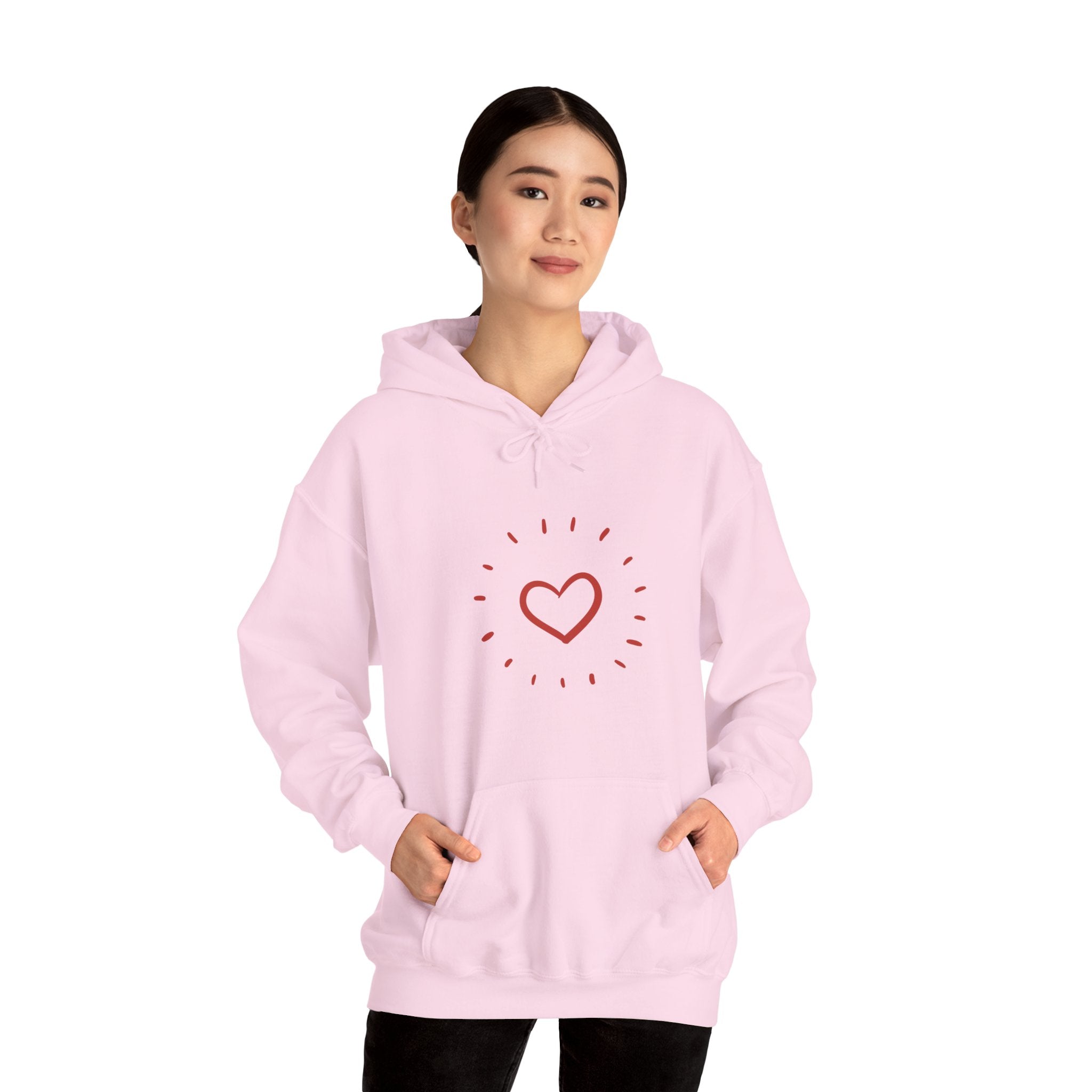 Person wearing a pink hoodie with a heart design on a white background