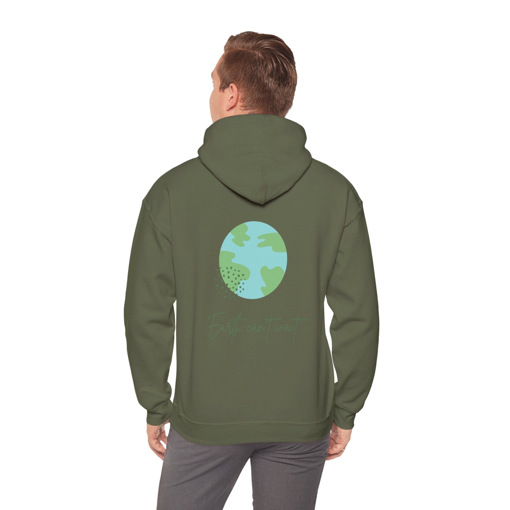 Person wearing a green hoodie with a globe design on the back, standing against a white background