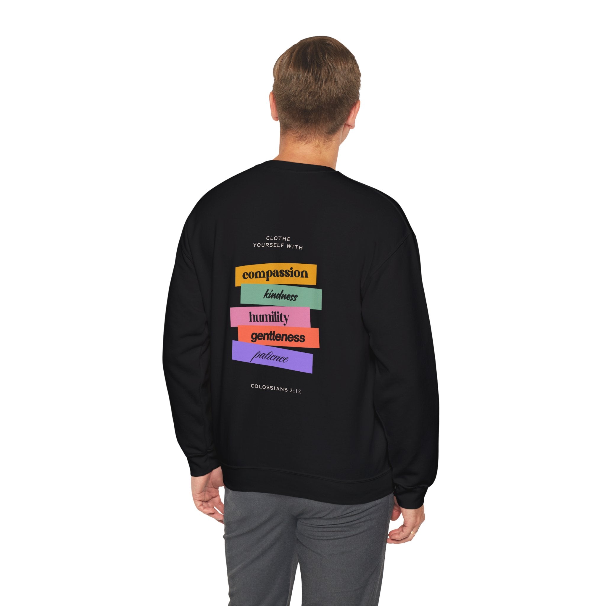 Person wearing a black sweatshirt with colorful text on the back against a white background