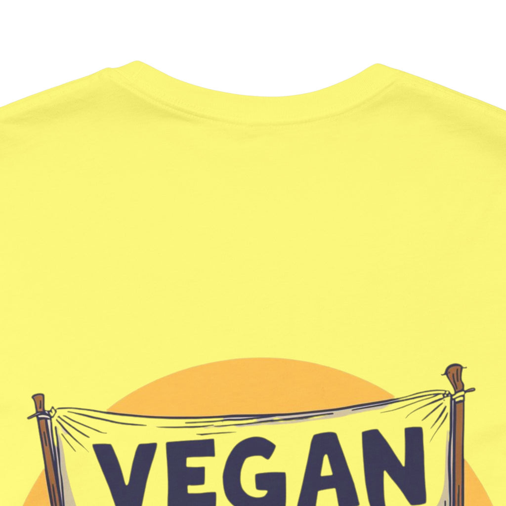 Yellow t-shirt with 'VEGAN' text and banner design on a white background