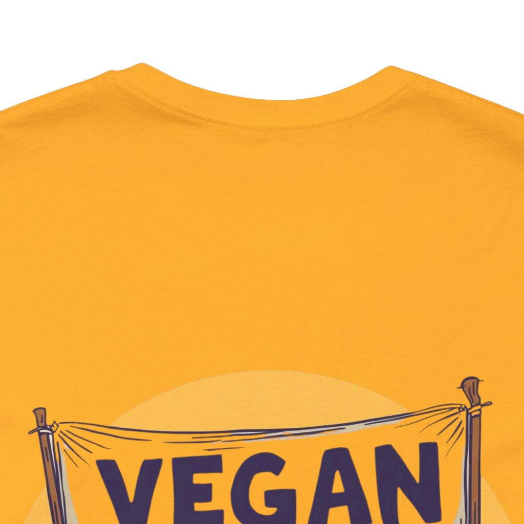 gold t-shirt with 'VEGAN' text on a white background