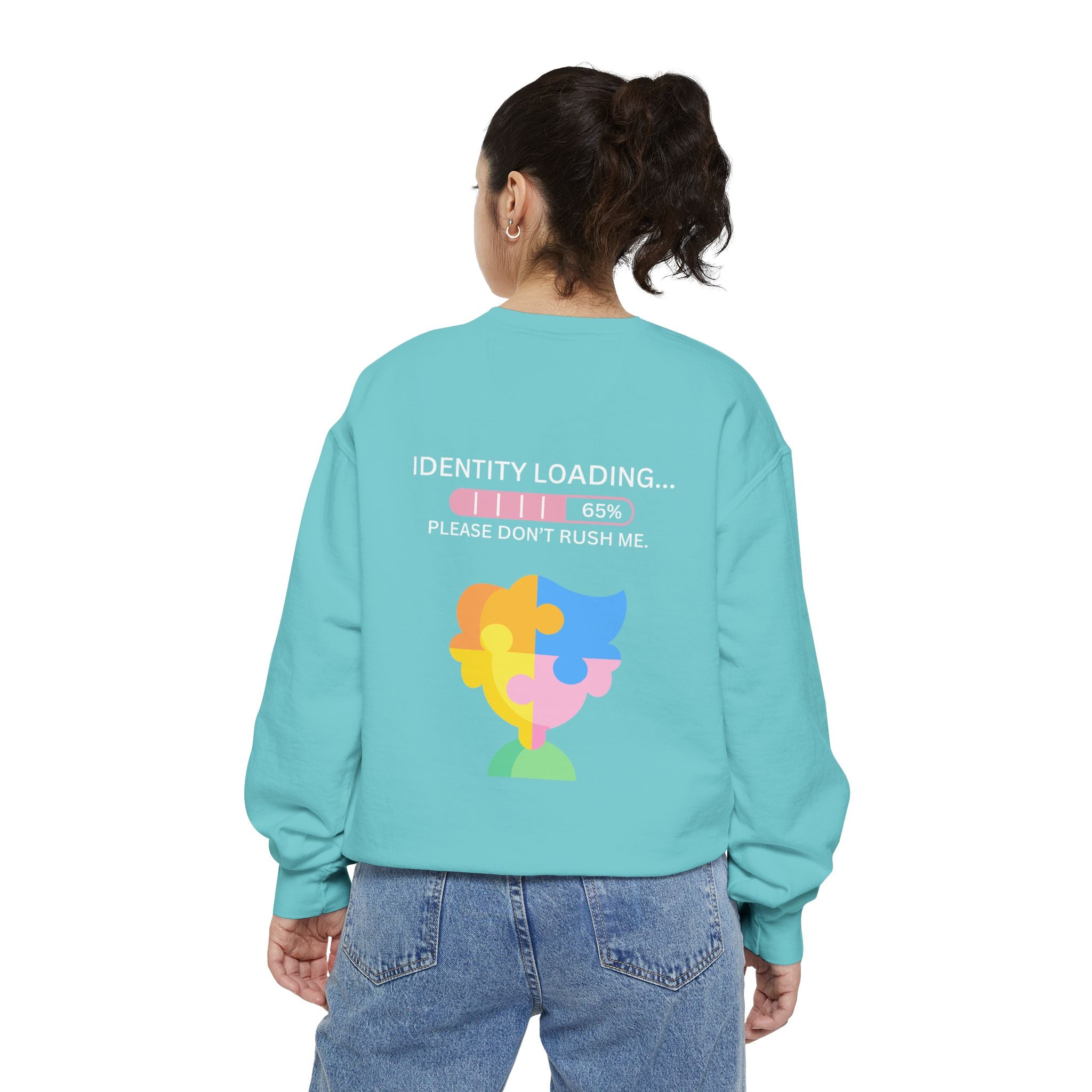 Person wearing a light blue sweatshirt with a colorful design and text on the back.