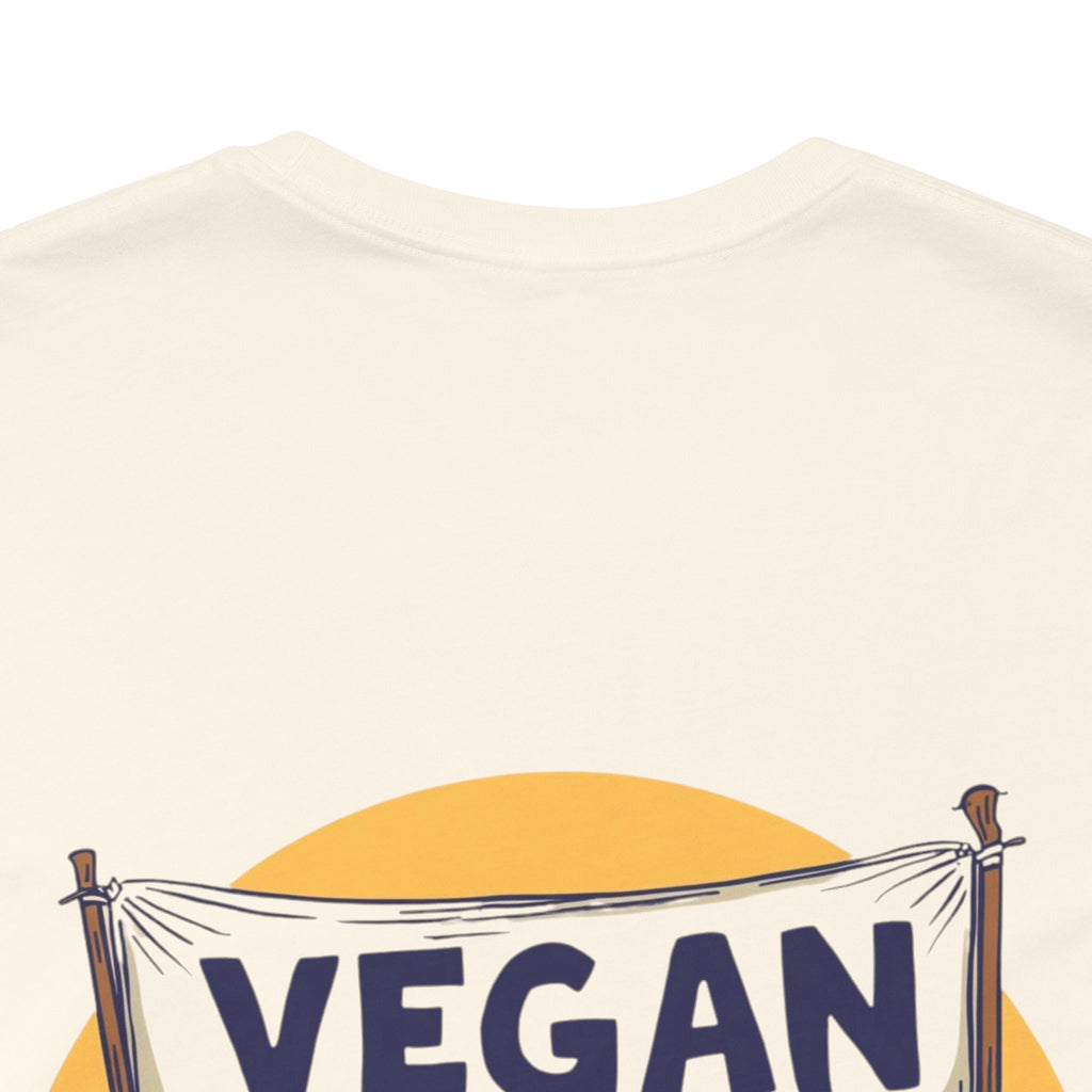Beige t-shirt with 'VEGAN' banner design on a white background