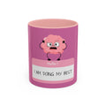 Pink mug with cartoon brain design and text on a white background