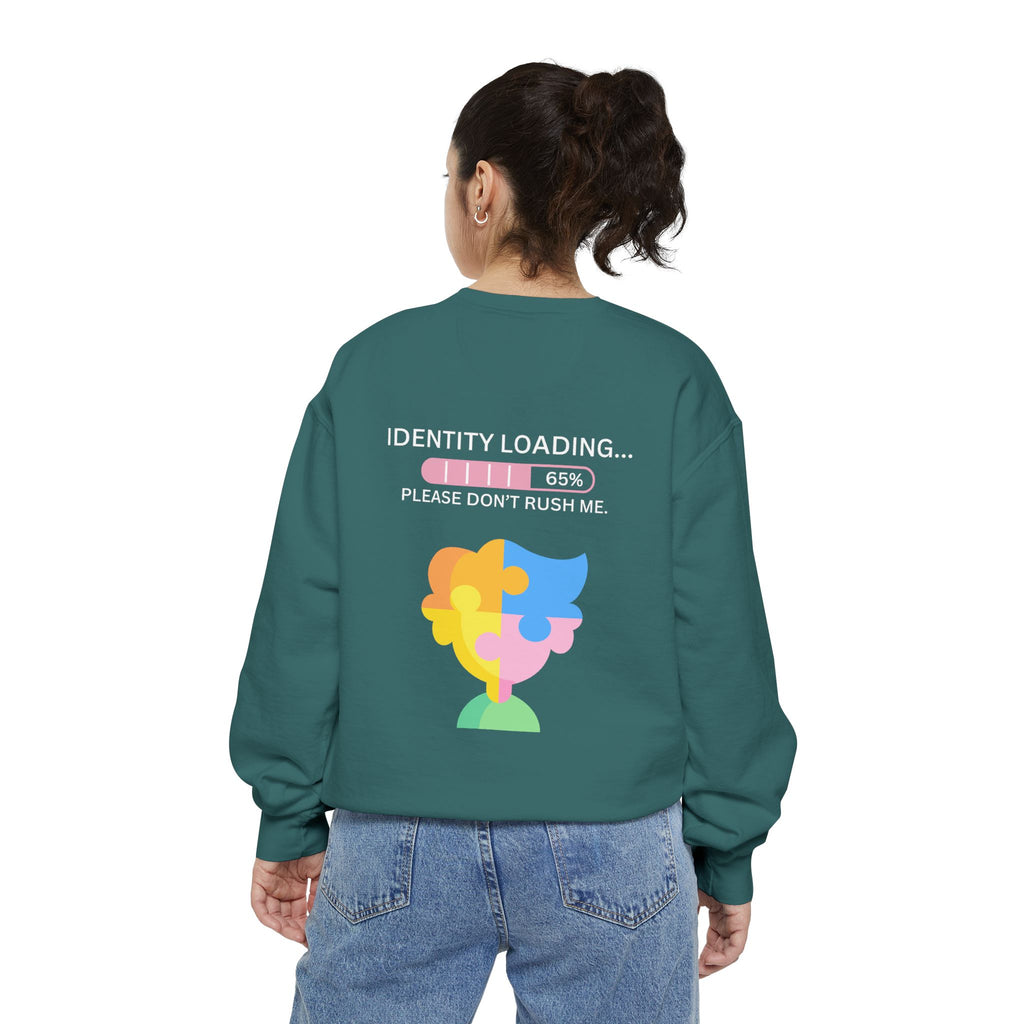Person wearing a green sweatshirt with a colorful graphic and text on the back, on a white background