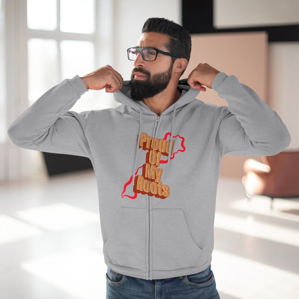 Man wearing a gray hoodie with 'Proud of My Roots' text and design, indoors.