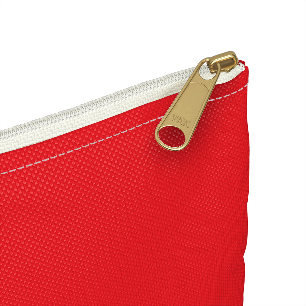 Close-up of a red pouch with a gold zipper on a white background