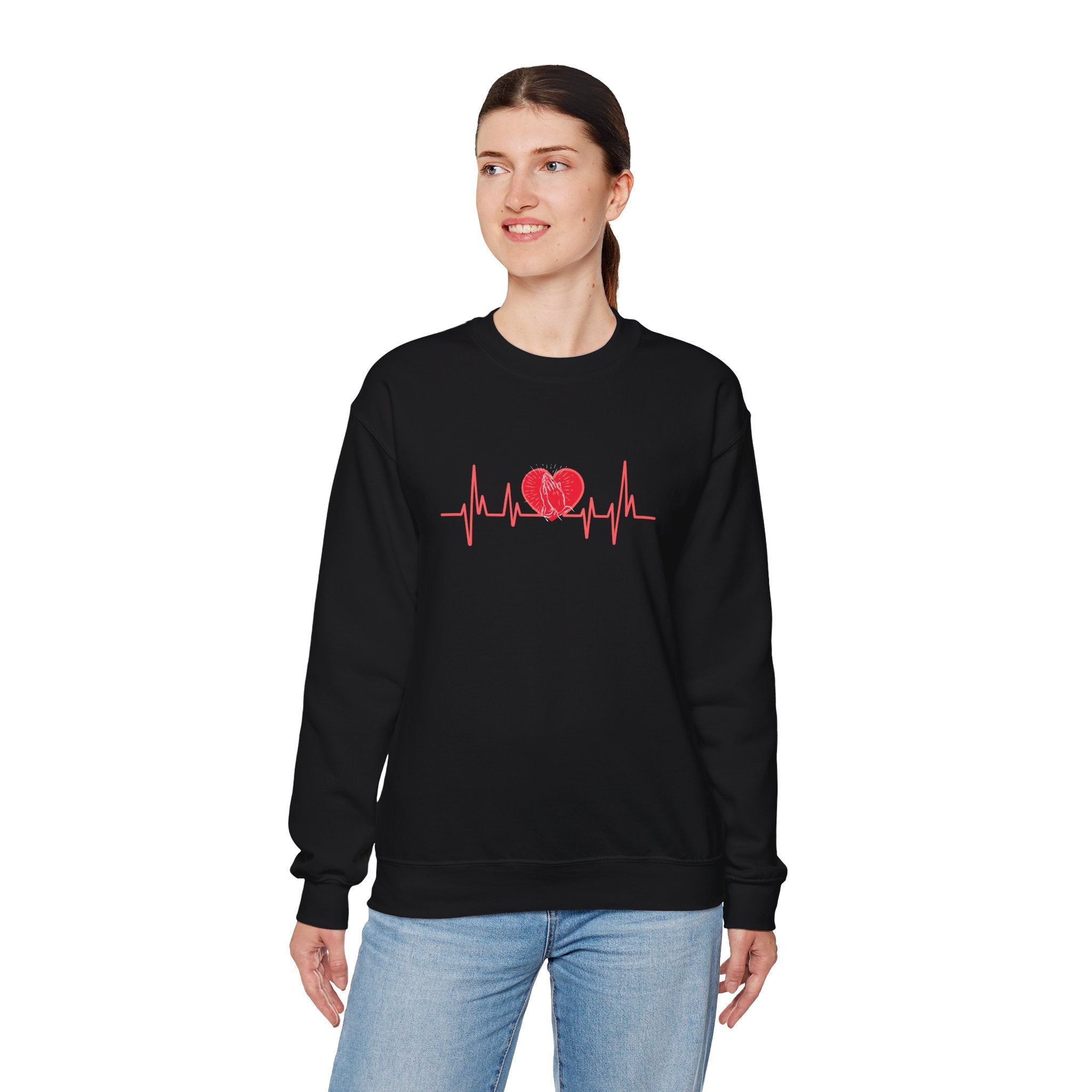 Person wearing a black sweatshirt with a red heart and heartbeat line design on a white background