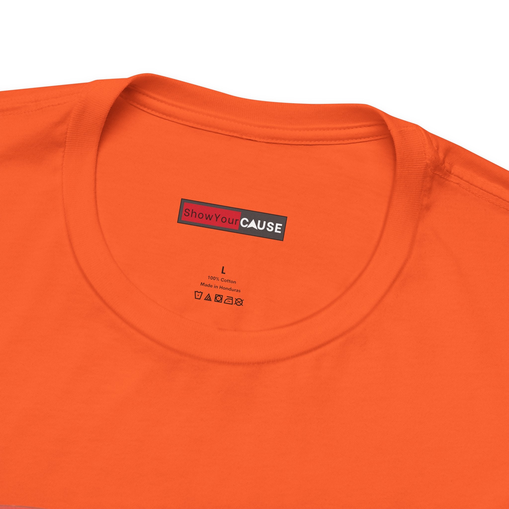 Close-up of an orange t-shirt with a 'Show Your Cause' label on a white background