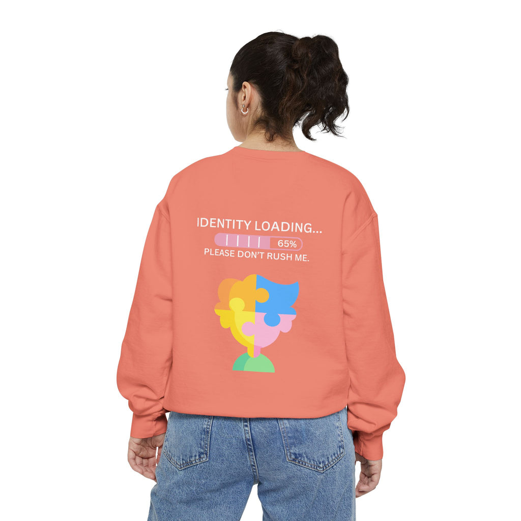 Person wearing a peach sweatshirt with a colorful graphic and text on the back, on a white background