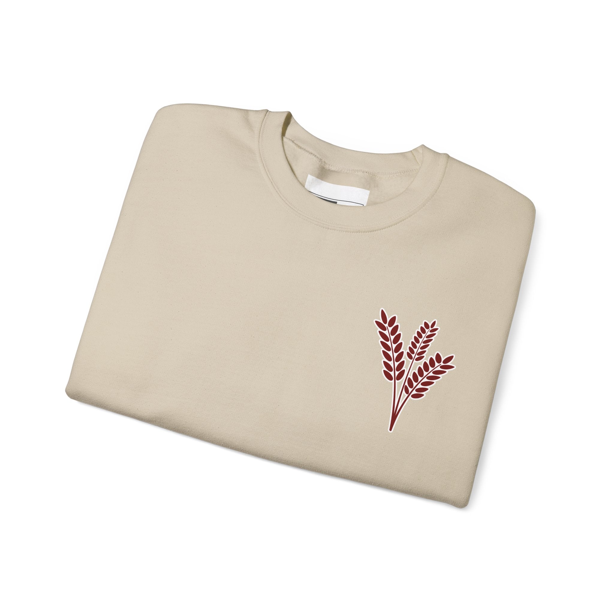 Beige sweatshirt with red leaf design on a white background