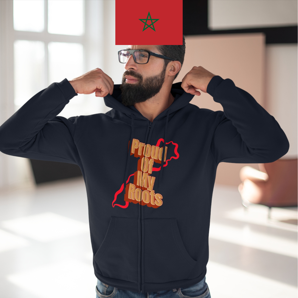 Man wearing a black hoodie with a red and orange design, standing indoors.