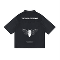 A black short-sleeve button-up shirt shown from the back, featuring a white graphic of a cicada in the center and white Cyrillic text above it, displayed on a solid white background.