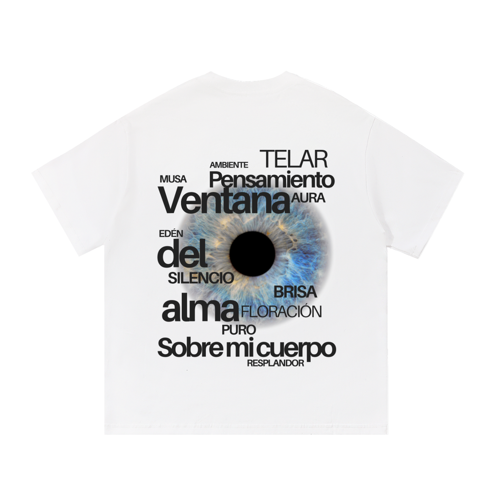 White short-sleeve t-shirt with a graphic print of a human eye in the center, surrounded by various Spanish words in black text.