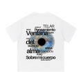 White short-sleeve t-shirt with a graphic print of a human eye in the center, surrounded by various Spanish words in black text.