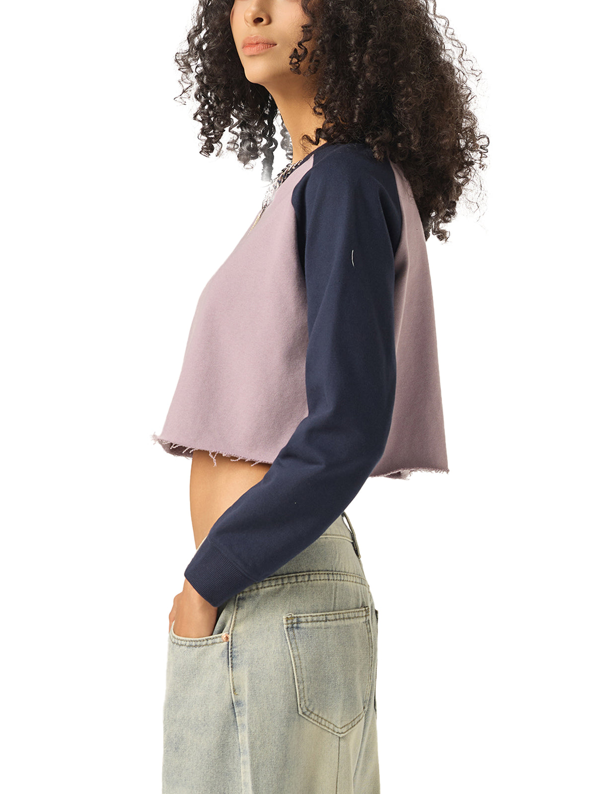 Person wearing a two-tone crop top with navy and pink colors on a white background