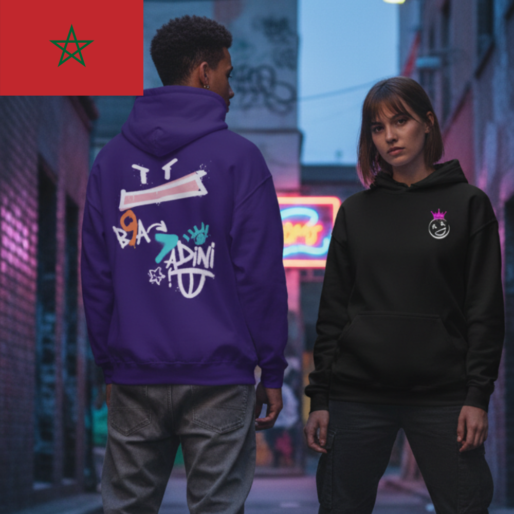 Two people wearing hoodies with visible branding in an urban setting.
• &nbsp; &nbsp; “B9a 7addini, ana l’focus.”
• &nbsp; &nbsp; “L3in dyalk ma kay7idch m3aya.”
• &nbsp; &nbsp; “Street vibes, b9a 7addini.”
• &nbsp; &nbsp; “Ana hna, w nta b9a 7addini.”