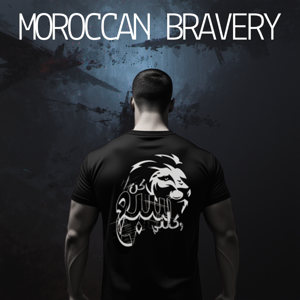 Man wearing a black t-shirt with a white graphic design on the back, set against a dark background with 'Moroccan Bravery' text.
Black tee back white lion Arabic calligraphy Be a lion and devour me text, ShowYourFight collection, Moroccan Bravery design, dark fearless streetwear.
“Born from fire, ruled by courage.”

“ShowYourFight, show your roar.”

“Moroccan Bravery — fear is the prey.”

“In darkness, lions rise.”