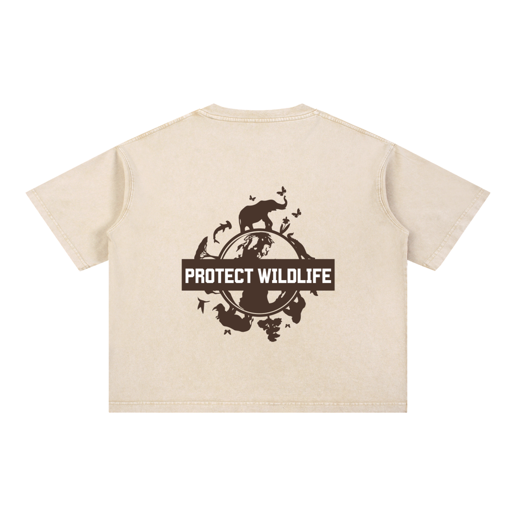 A light beige short-sleeve crop top shown from the back, featuring a dark brown graphic with silhouettes of animals and a central banner that reads 'PROTECT WILDLIFE'.